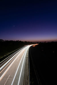 High angle view of light trails on highway at night