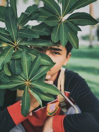 Portrait of young man by plants