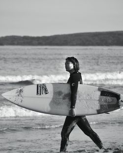 Man with surfboard on beach