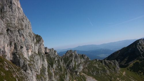 Scenic view of rocky mountains against clear blue sky