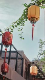 Low angle view of lanterns hanging against sky