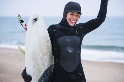 Young woman going winter surfing in snow