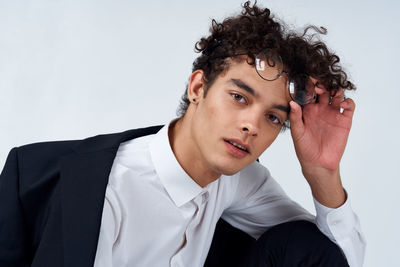 Portrait of young man against white background