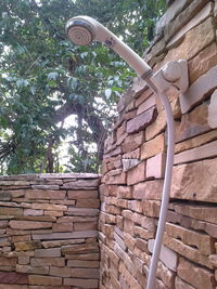 Low angle view of stone wall by building