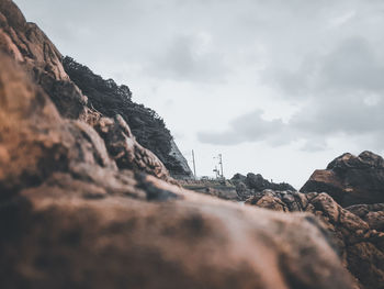 Surface level of rock formation against sky