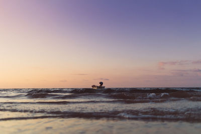 Tiny boat isolated on the sea on colorful sunset. concept of lonely.