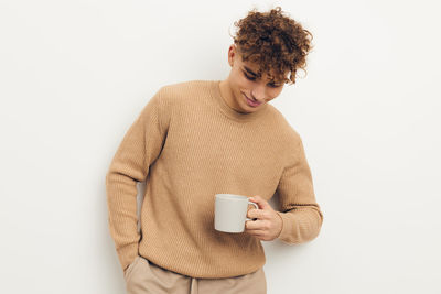 Man holding mug against white background