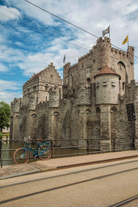 Bridge and bike in front of gravensteen castle in ghent. a city full of gothic buildings in belgium.