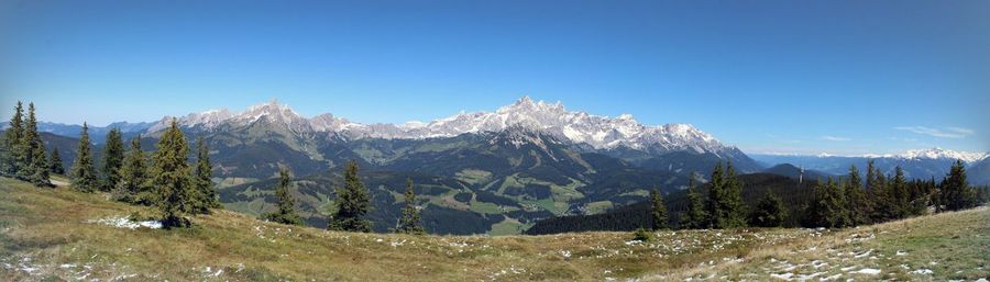 Scenic view of mountains against clear blue sky