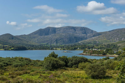Scenic view of lake and mountains against sky