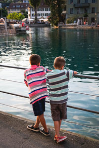 Rear view of friends on water