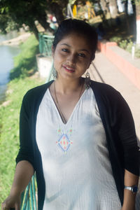 Portrait of smiling woman standing outdoors