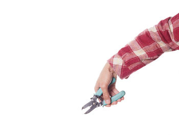 Close-up of hand holding hands over white background