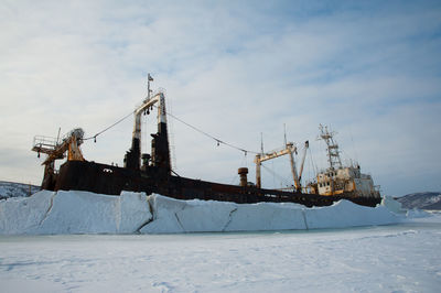 View of abandoned ship during winter against sky