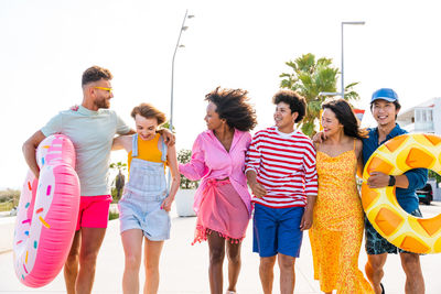 Group of friends standing against white background