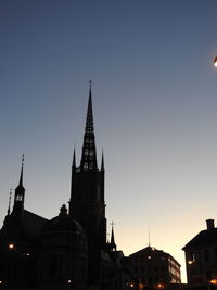 View of buildings in city against clear sky