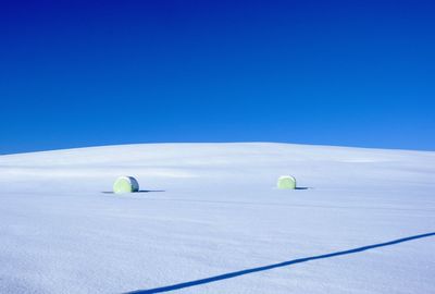 Scenic view of beach against clear blue sky