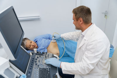 Doctor using laptop at clinic