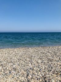 Scenic view of sea against clear blue sky