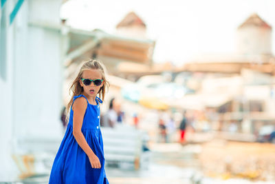 Portrait of young woman standing outdoors