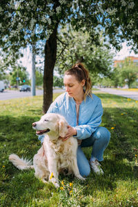 Portrait of young woman sitting on grass