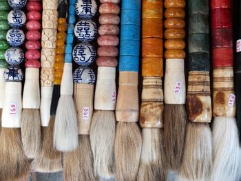 Full frame shot of various colorful brushes for sale at market