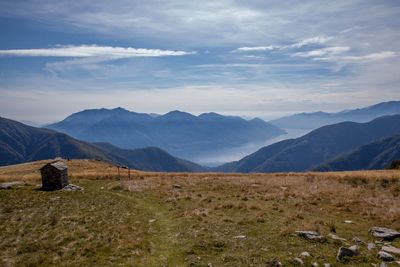 Scenic view of landscape and mountains against sky