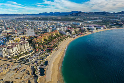High angle view of sea and buildings against sky