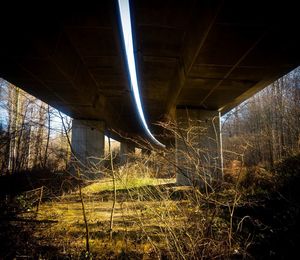 Low angle view of illuminated bridge at night