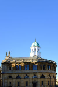 Low angle view of church against clear blue sky