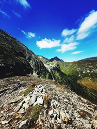 Scenic view of mountains against blue sky