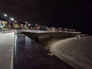 View of illuminated street at night