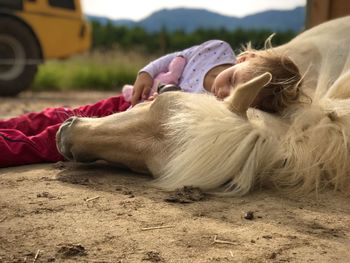 Full length of girl sleeping on field