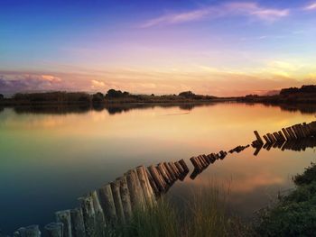 Scenic view of calm lake at sunset