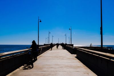 Pier on sea against clear sky