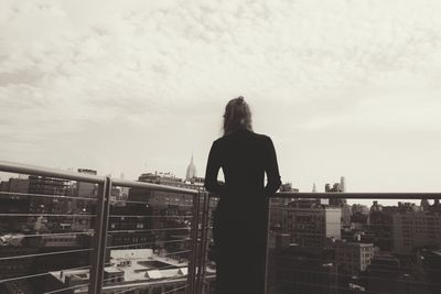 Rear view of man looking at city