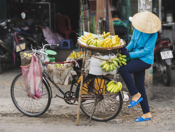 Man with fruits on bicycle at market