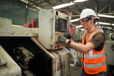 Portrait of male worker standing in the heavy industry manufacturing factory.