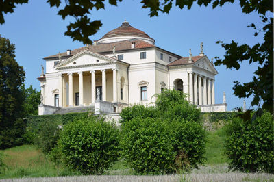 Castle by trees against sky