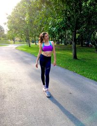 Full length portrait of young woman in park