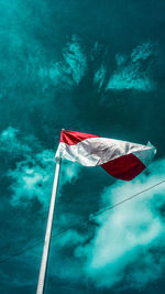 Low angle view of flag flags against sky