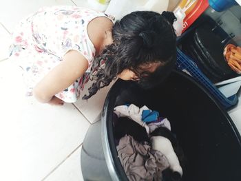 High angle view of girl looking in tub at home