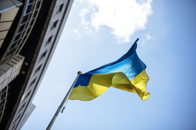 Low angle view of ukranian flag against sky next to the european parliament