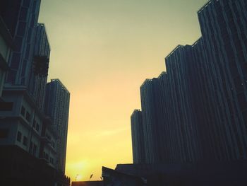 Low angle view of buildings at sunset