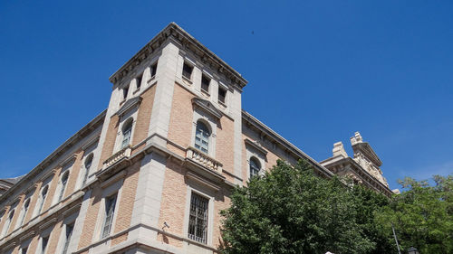 Low angle view of building against clear blue sky