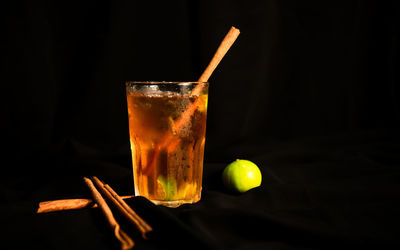 Close-up of drink on table against black background