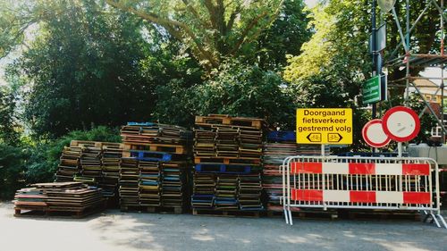 Stack of trees against stone wall