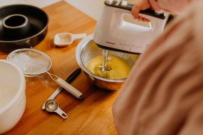 Child mixing ingredients for baking a cake