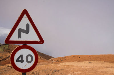 Road sign against clear sky