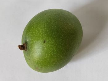 High angle view of apple on table against white background